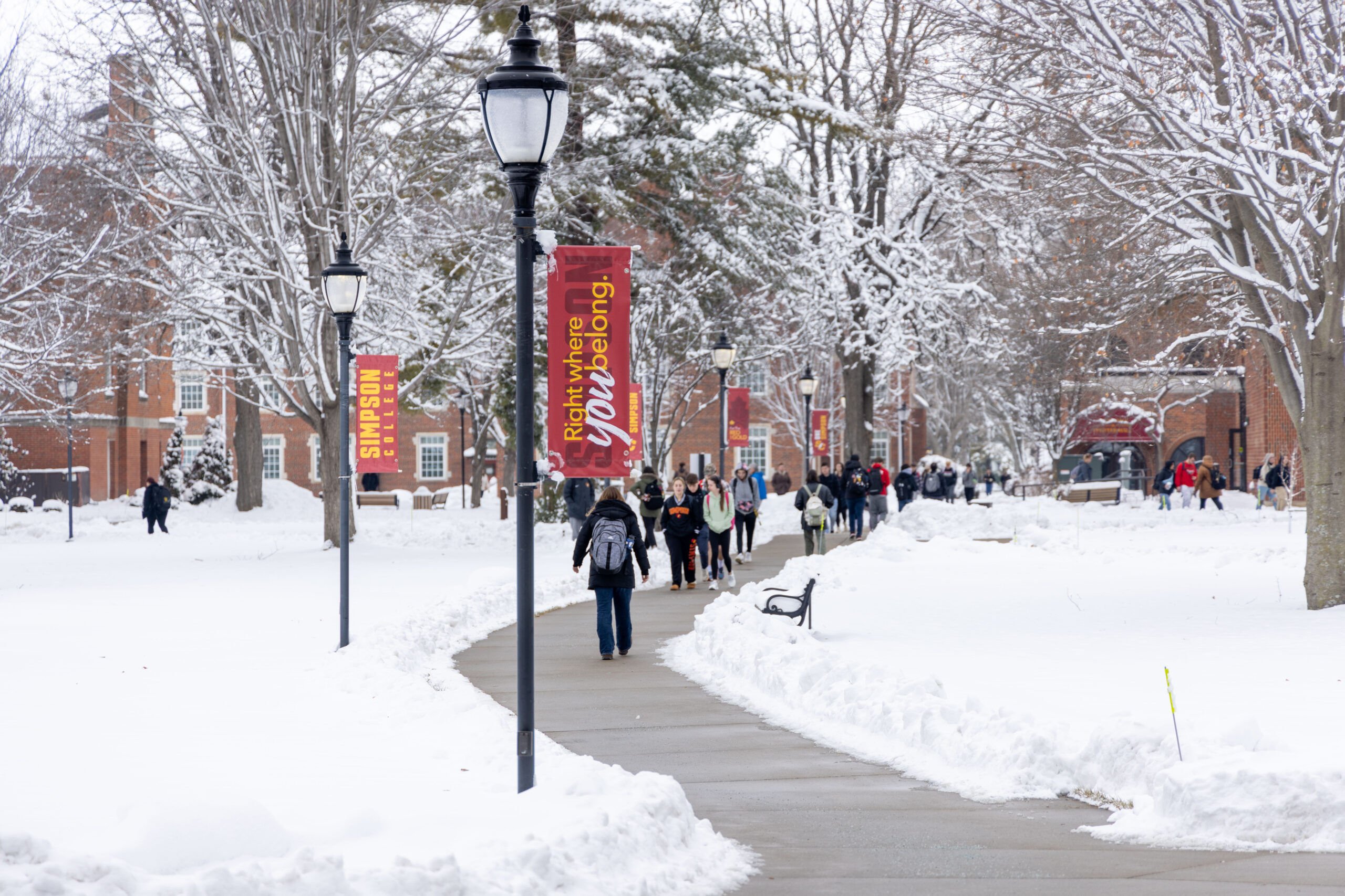 Students walking across a snowy Simpson campus