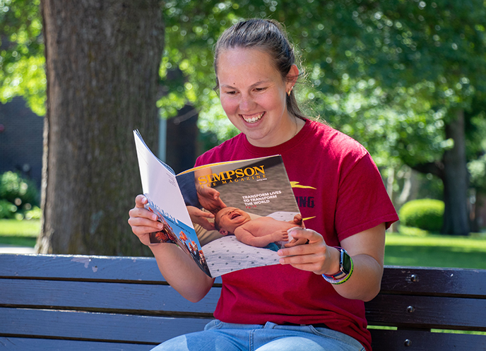 Student reading The Simpson Magazine