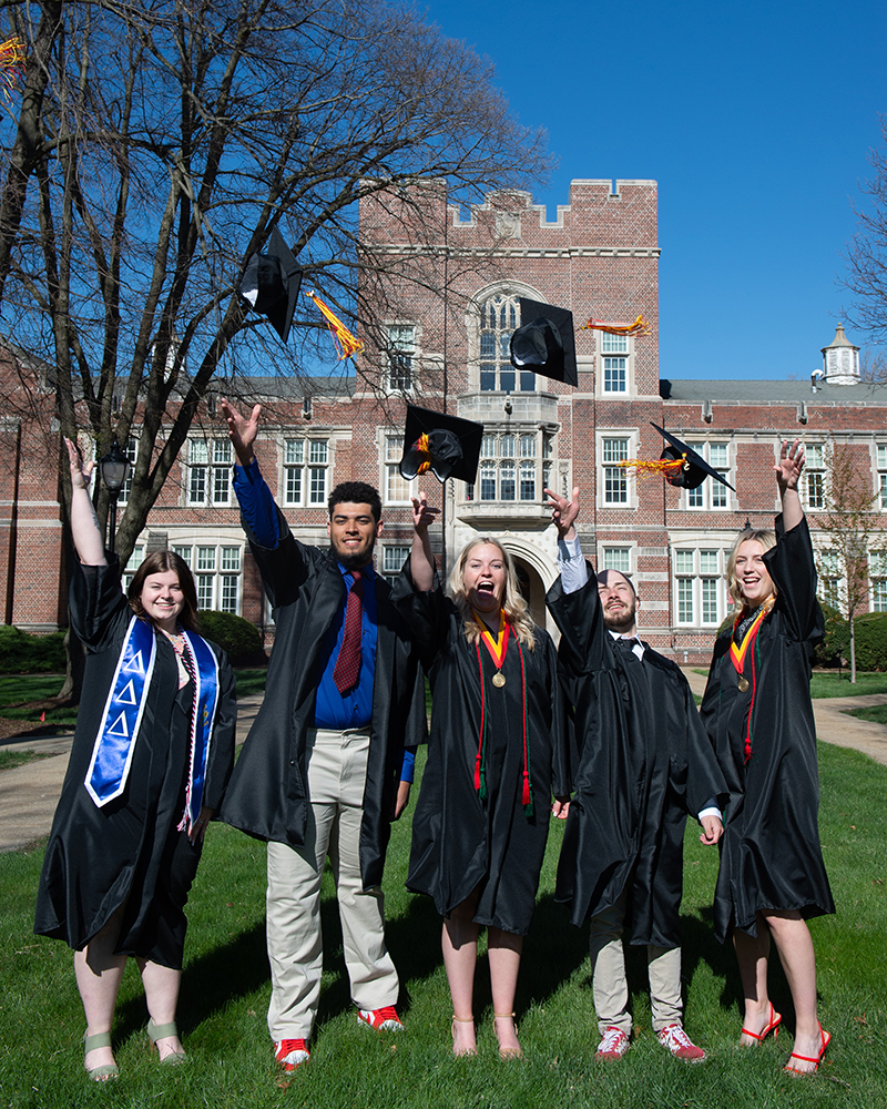 Students at commencement throwing up their caps