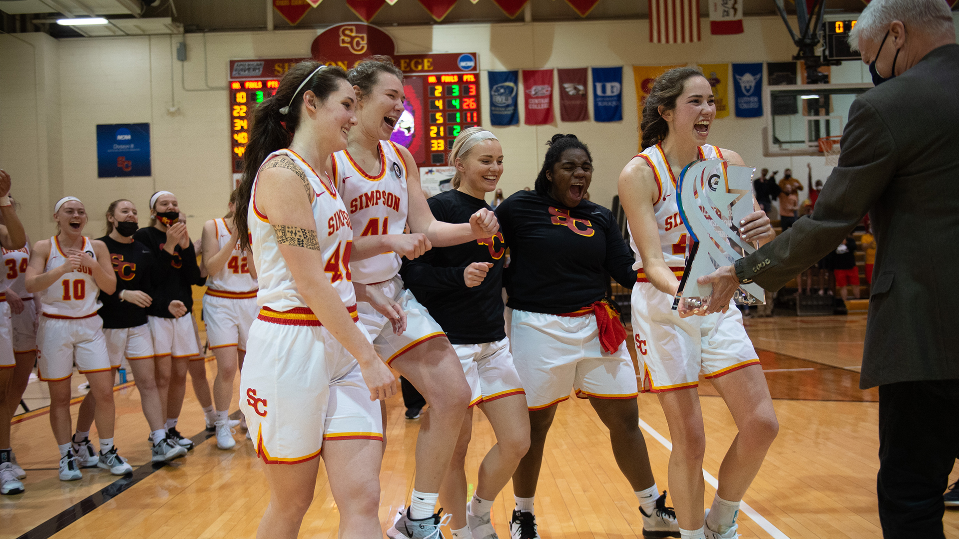 Seniors members of the Simpson College women's basketball team collect the American Rivers Conference Championship trophy.