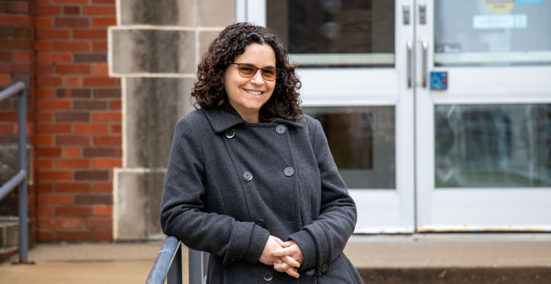 Professor Heidi Berger standing in front of Carver Hall.