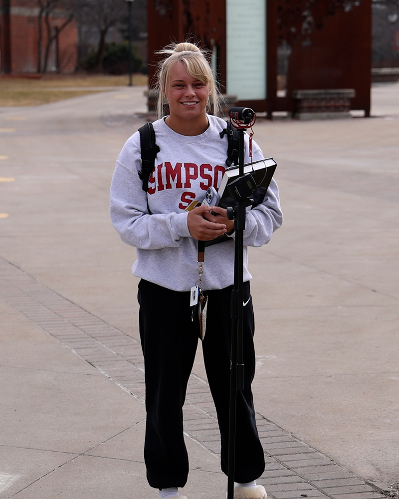 Student with microphone smiling